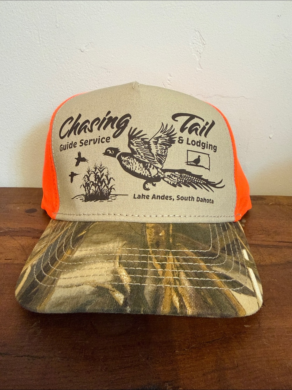 Chasing Tail Guide Service Trucker Hat - Tan & Orange with Camo Brim